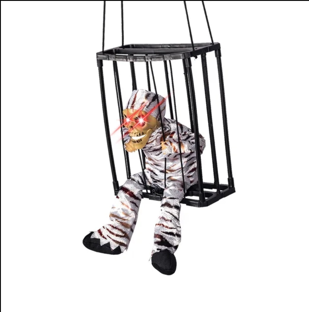 Scary screaming Halloween decor in cage